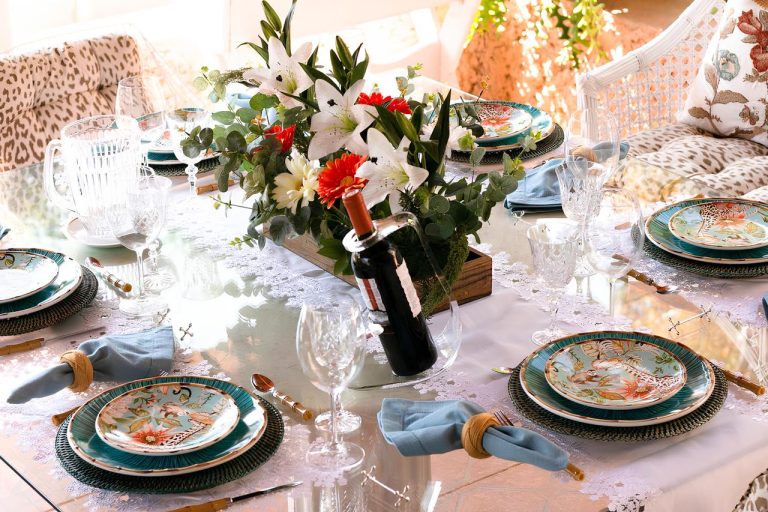 Beautifully arranged table with floral centerpiece and colorful plates indoors.